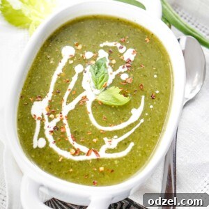 vegan green detox soup with cream in a white bowl