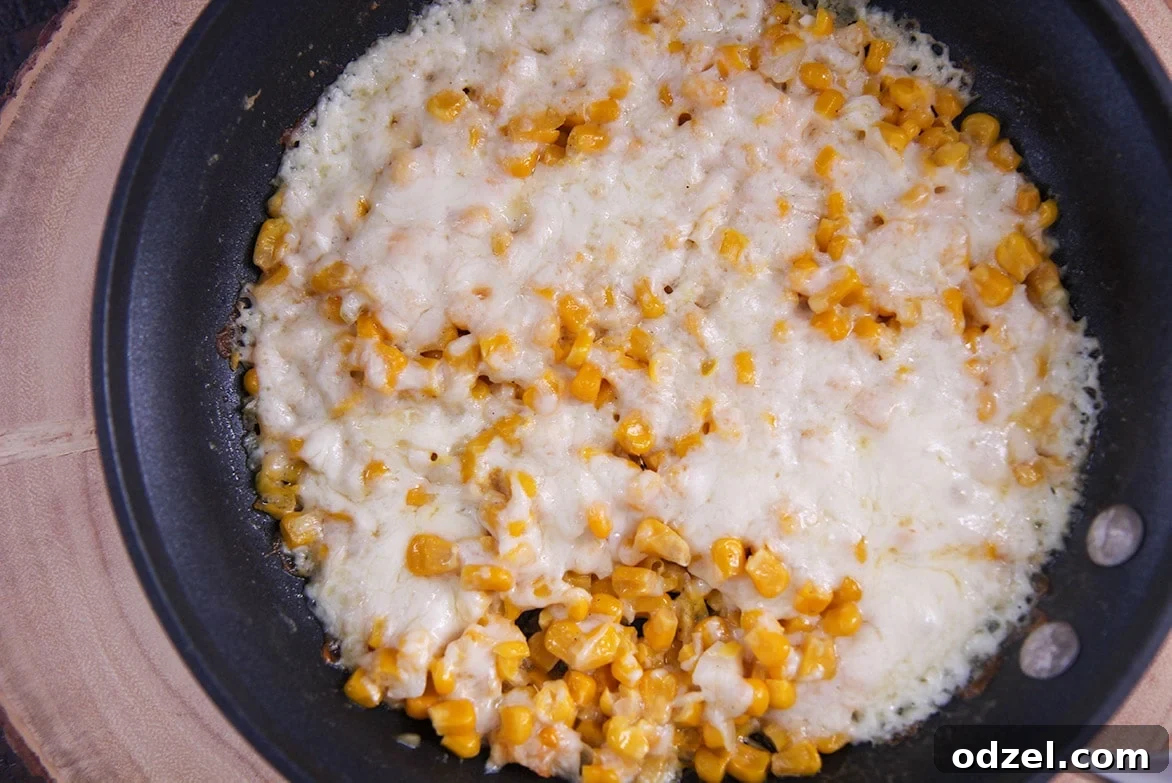 cheesy corn in a skillet.