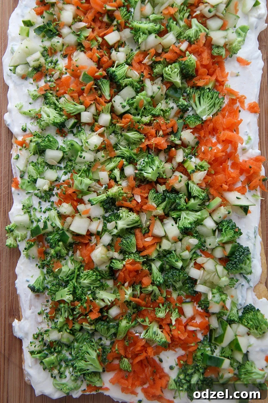 Delicious and colorful veggie bars arranged beautifully on a rustic wooden board, garnished with fresh herbs, ready to be served as an appetizer.