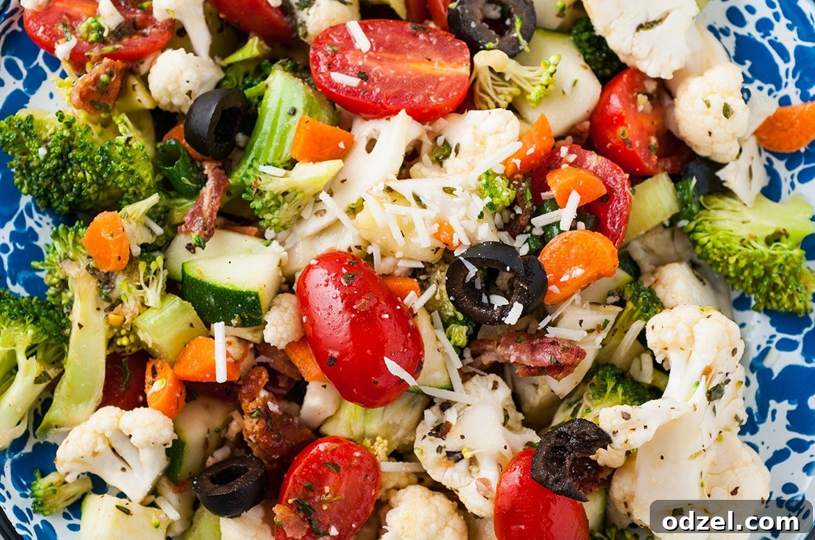 A close-up view of crunchy vegetable salad with homemade Italian dressing, highlighting the vibrant fresh ingredients.