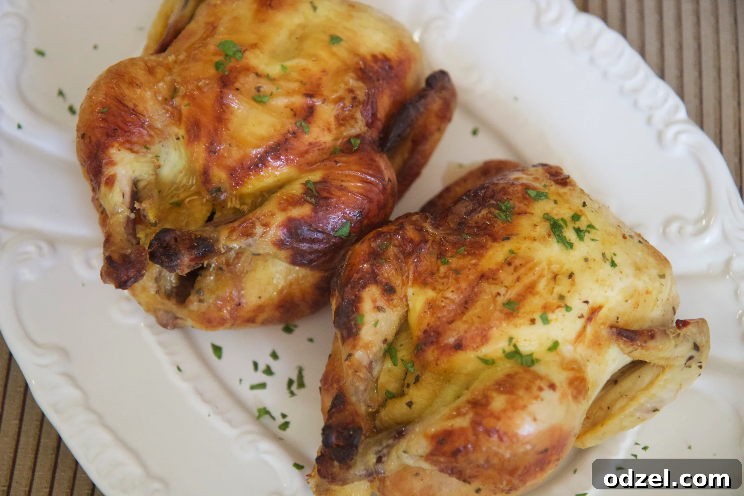 A beautifully presented roasted Cornish hen dinner, served with roasted vegetables and mashed potatoes, ideal for formal dining or a relaxed family meal.