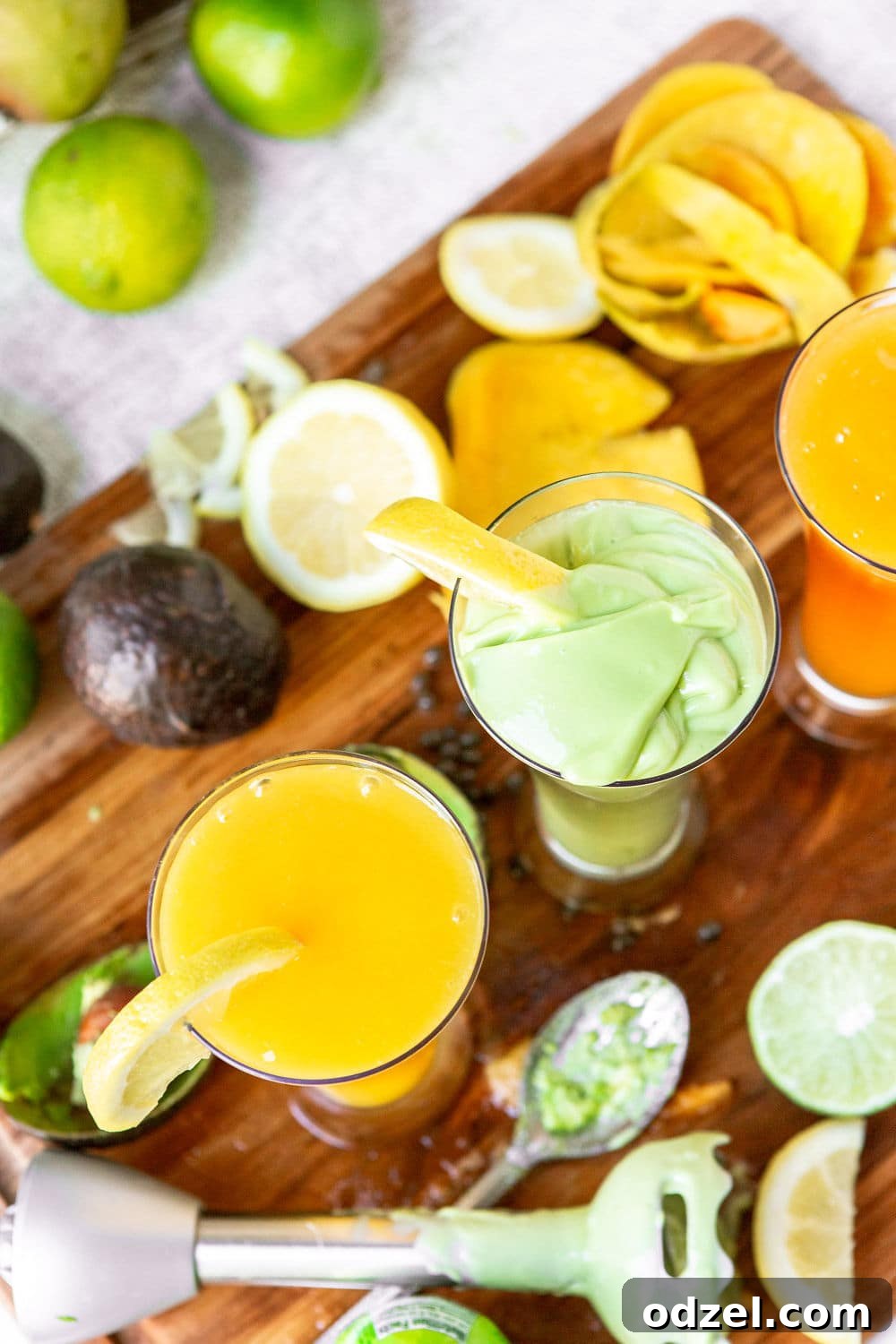 Layered Ethiopian Spris 5 Two tall glasses filled with a refreshing, layered green and yellow juice, with an immersion blender resting beside them, illustrating the preparation of a vibrant Ethiopian Spris.