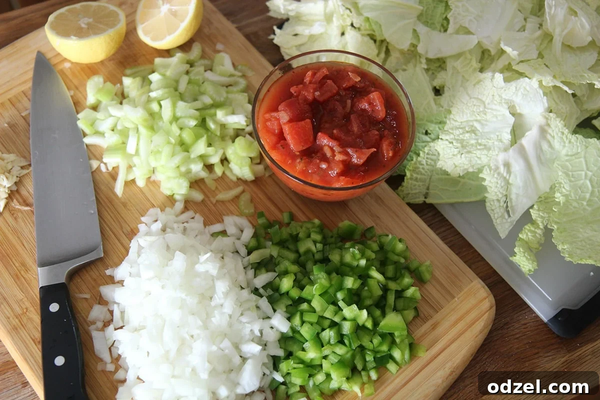 A vibrant assortment of chopped cabbage, onions, tomatoes, lemons, and bell peppers neatly arranged on a rustic wooden cutting board, ready for cooking.
