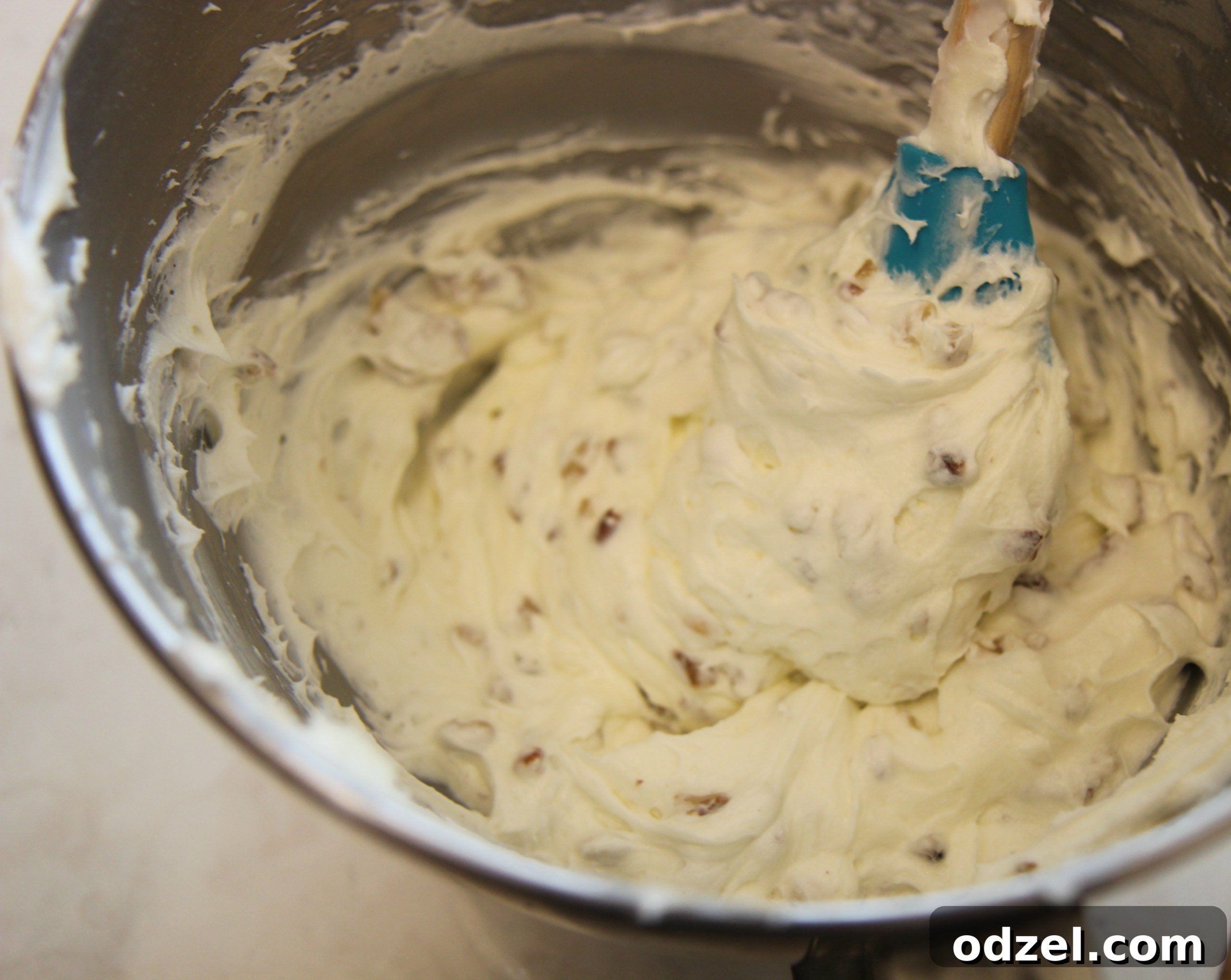 Creamy, sweet frosting is whipped together with chopped pecans, creating a luscious texture for the cake.