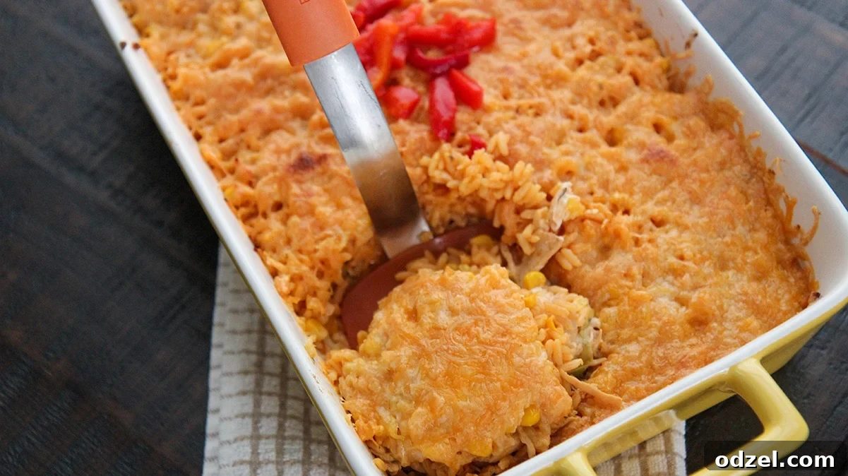 Royal Cuban Rice Bake 4 a casserole of imperial rice with an orange spatula lifting a portion out of the casserole.