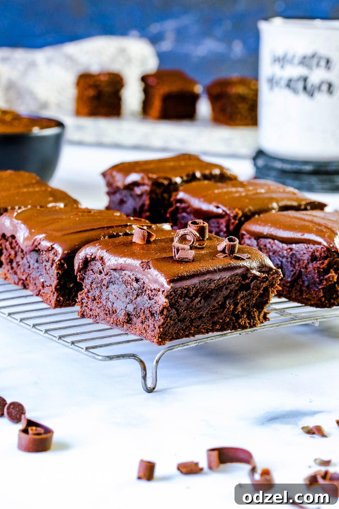 Six irresistibly fudgy chocolate brownies cooling on a wire rack, showcasing their rich texture and perfect tops, ready for a decadent fudge layer.