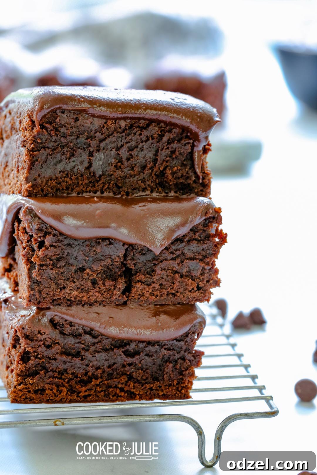 Rich chocolate fudge brownies arranged on a cooling rack, glistening with their smooth, homemade topping, ready to be enjoyed.