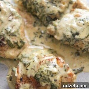 4 bone-in chicken thighs with spinach and cream on top.