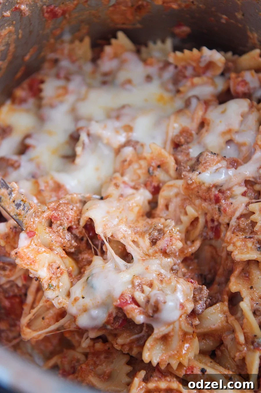 Instant Pot Lasagna Shortcut 2 Close-up of Instant Pot Lazy Lasagna with farfalle pasta and rich meat sauce, topped with melted cheese.