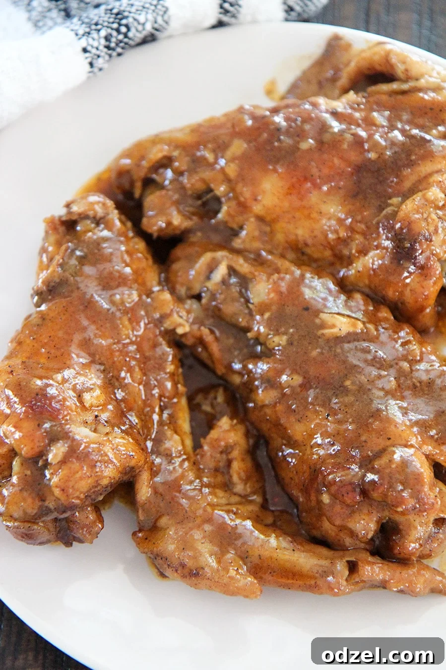 smothered wings on a white plate up close, showcasing the rich gravy and tender turkey meat.