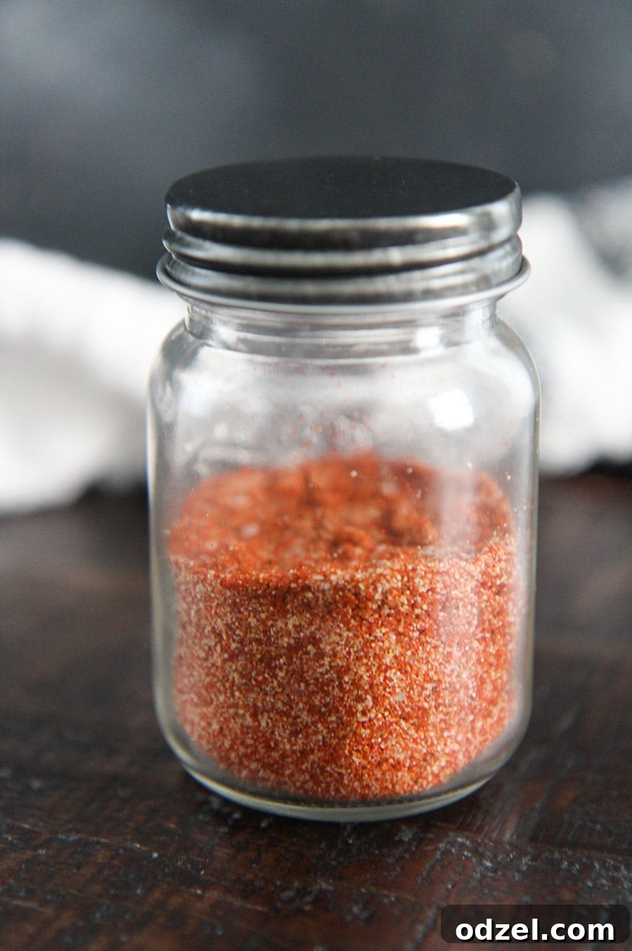Chipotle seasoning perfectly stored in a clear glass spice jar, ready for use in the kitchen.