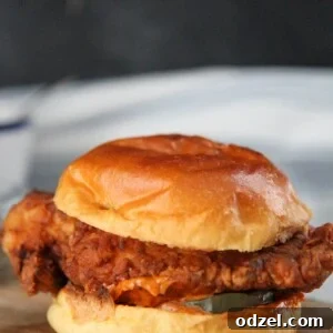popeye's fried chicken sandwich on a wooden board.