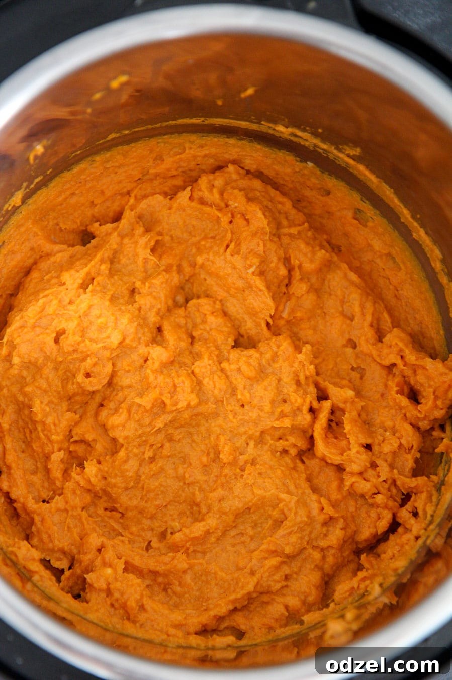 Creamy Instant Pot Sweet Potatoes 3 Mashed sweet potatoes actively cooking in the Instant Pot, showing the creamy texture and rich color, ready for final seasoning.