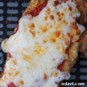 chicken parmesan in the black air fryer basket.