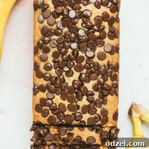 chocolate peanut butter banana bread with two bananas on the side