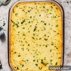 Baked Pastitsio in a glass baking dish with chopped parsley on top.