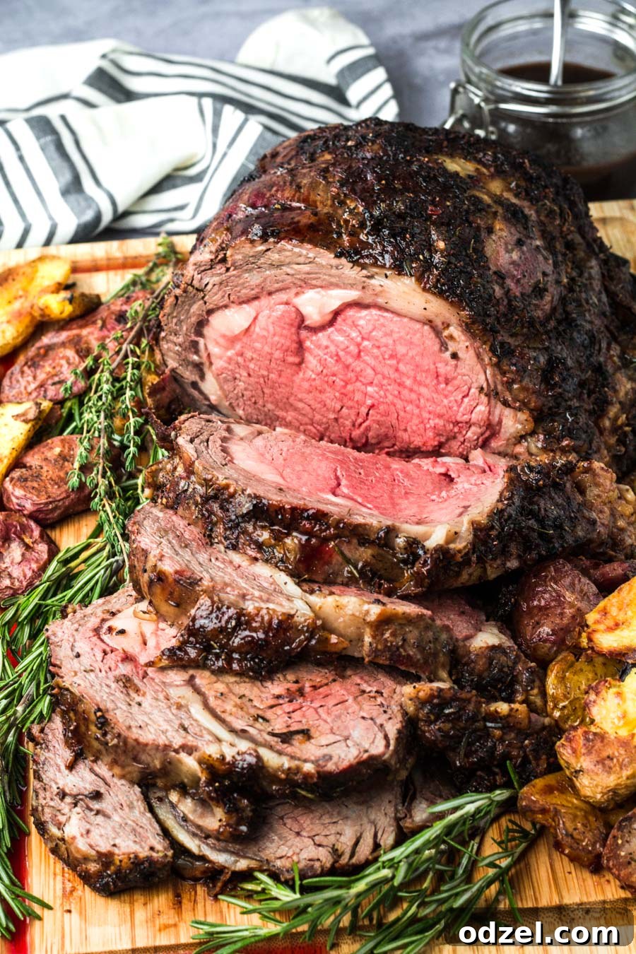 Juicy Prime Rib Masterpiece 2 Perfectly sliced medium-rare prime rib on a rustic wooden board, garnished with fresh rosemary and thyme.