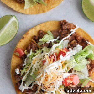 A perfectly assembled beef tostada, ready to be enjoyed, highlighting its layered deliciousness.