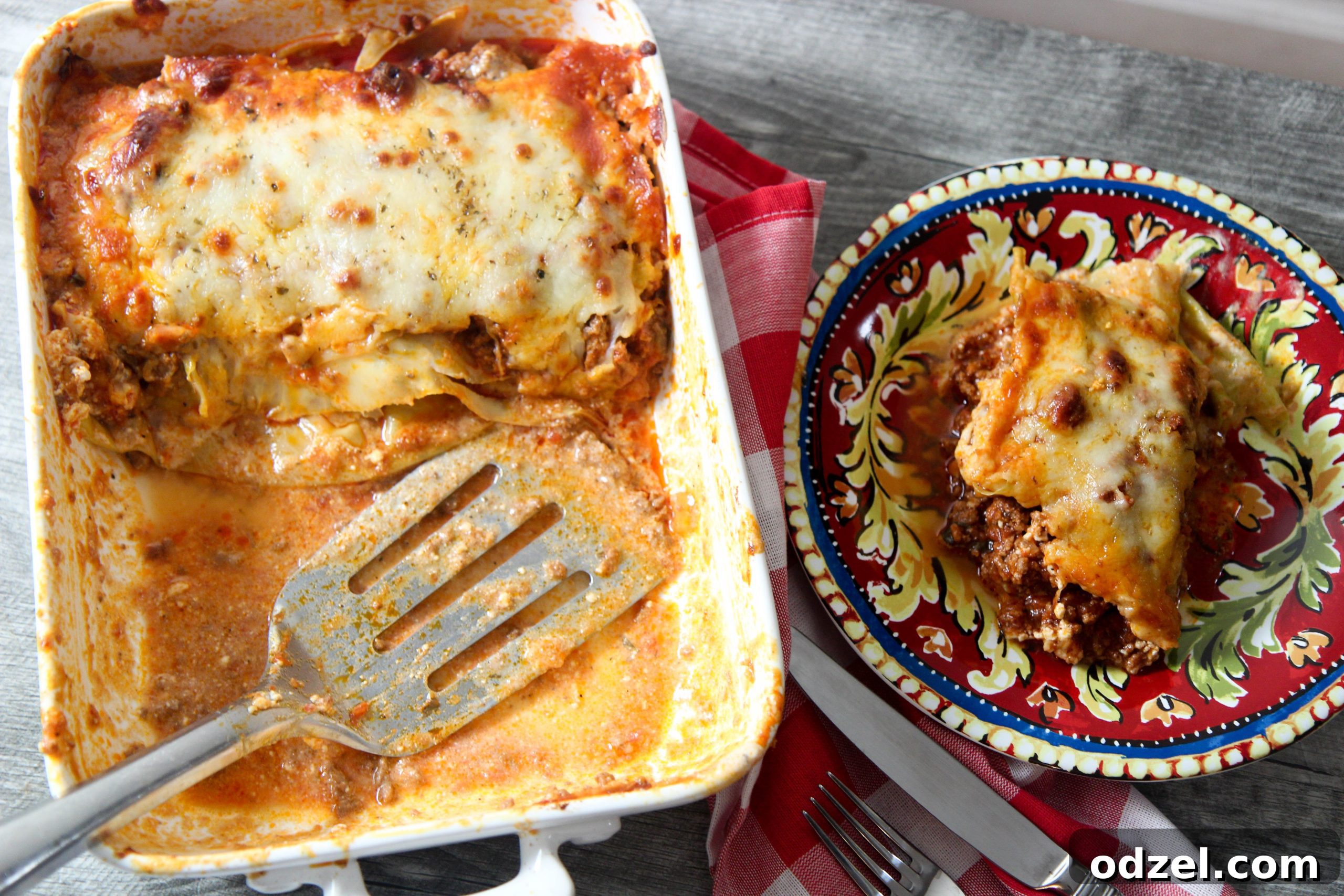 Keto Cabbage Lasagna Delight 3 A freshly baked low carb cabbage lasagna in a white skillet, with a single slice on a small plate next to it.