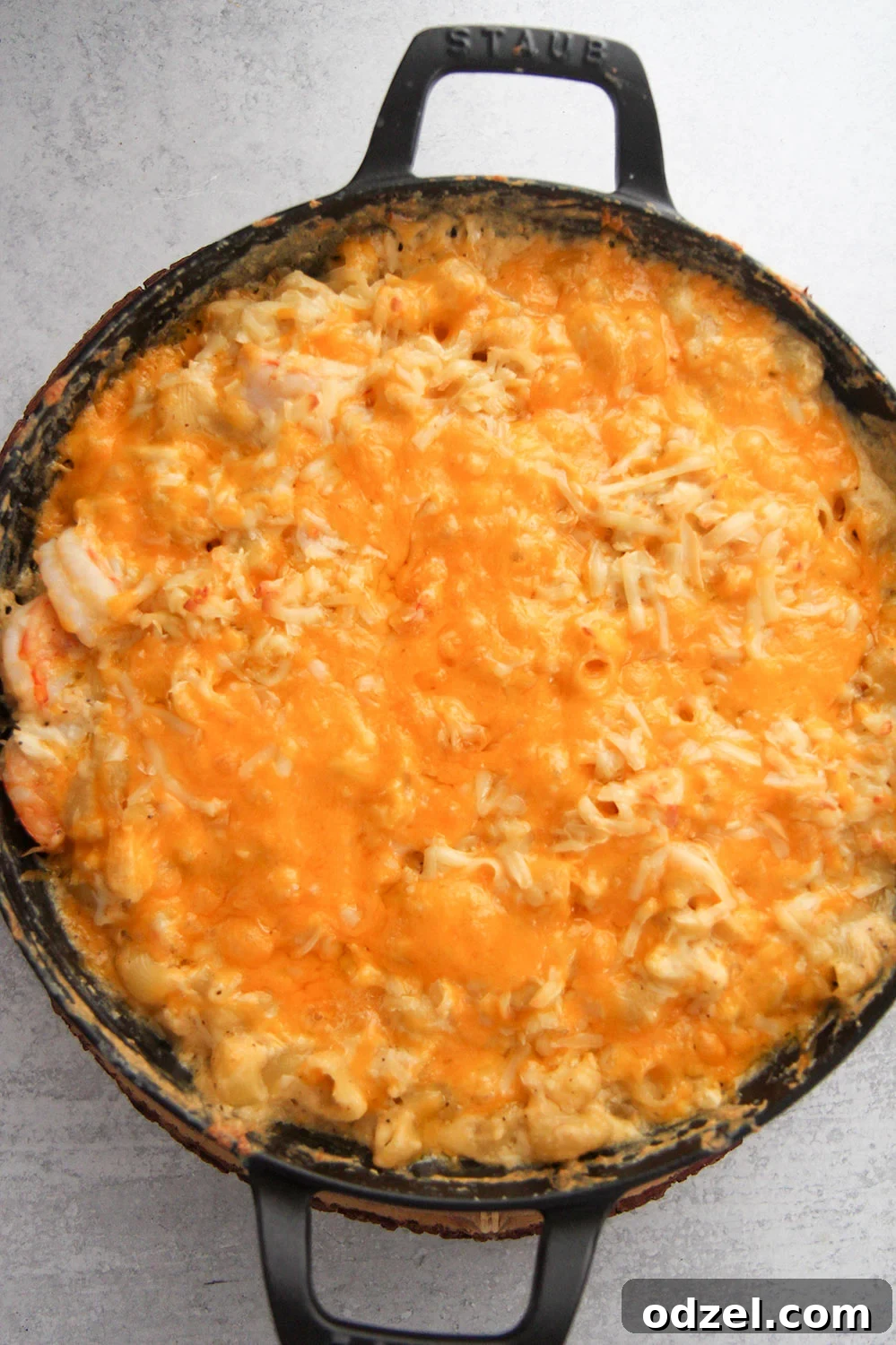 Creamy Seafood Macaroni 2 Seafood macaroni and cheese served in a black cast iron skillet, showcasing its creamy texture and rich ingredients.