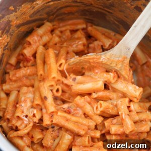 Delicious baked ziti in the Instant Pot, served with a wooden spoon