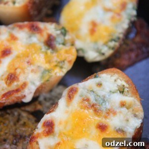 baked cheesy garlic bread slices up close, showcasing melted cheese and golden crust.