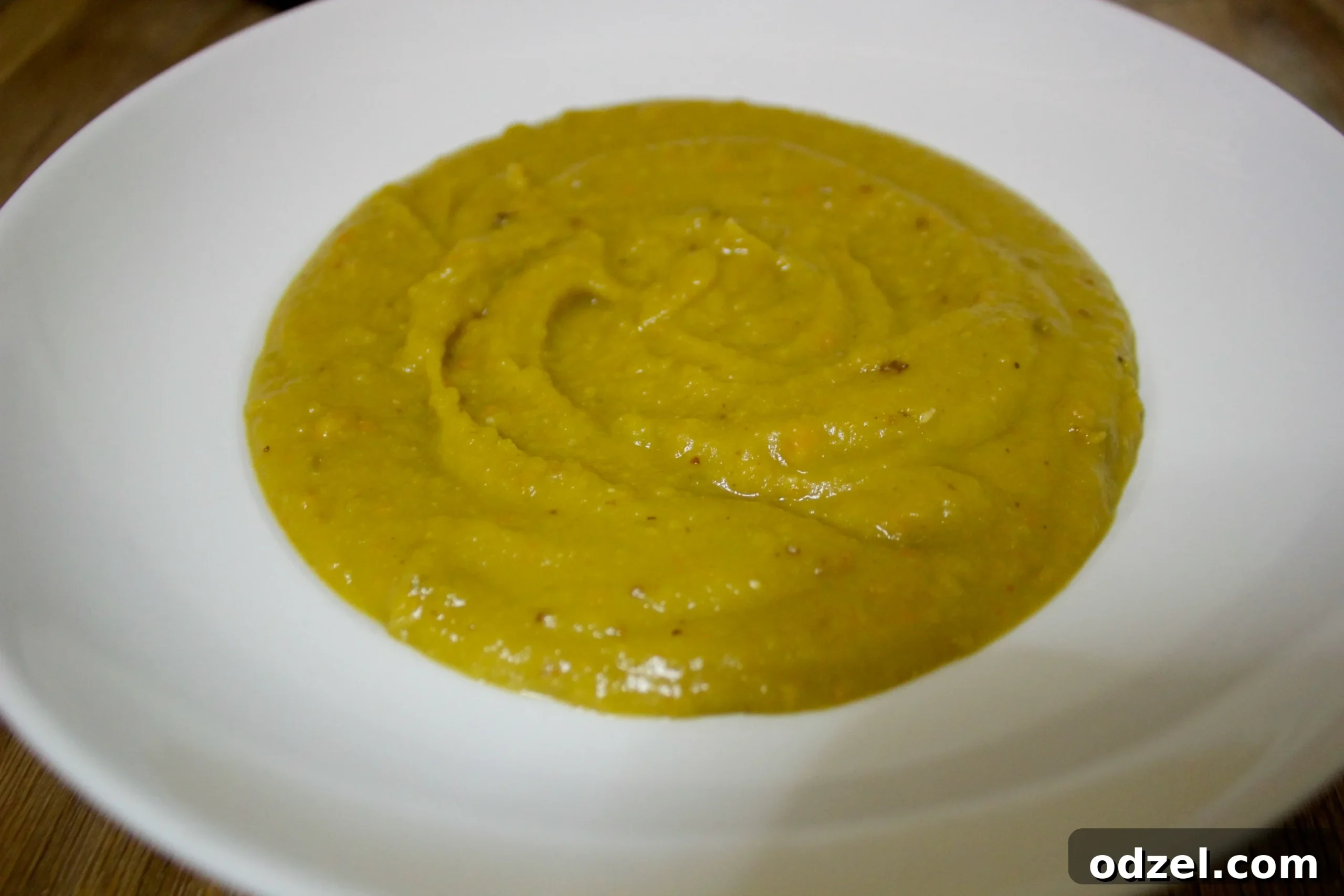 A steaming bowl of healthy and flavorful spicy split pea soup, perfect for a cold winter night