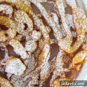 Funnel cake up close with powdered sugar on top.