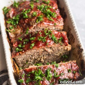 Sliced meatloaf garnished with fresh parsley.