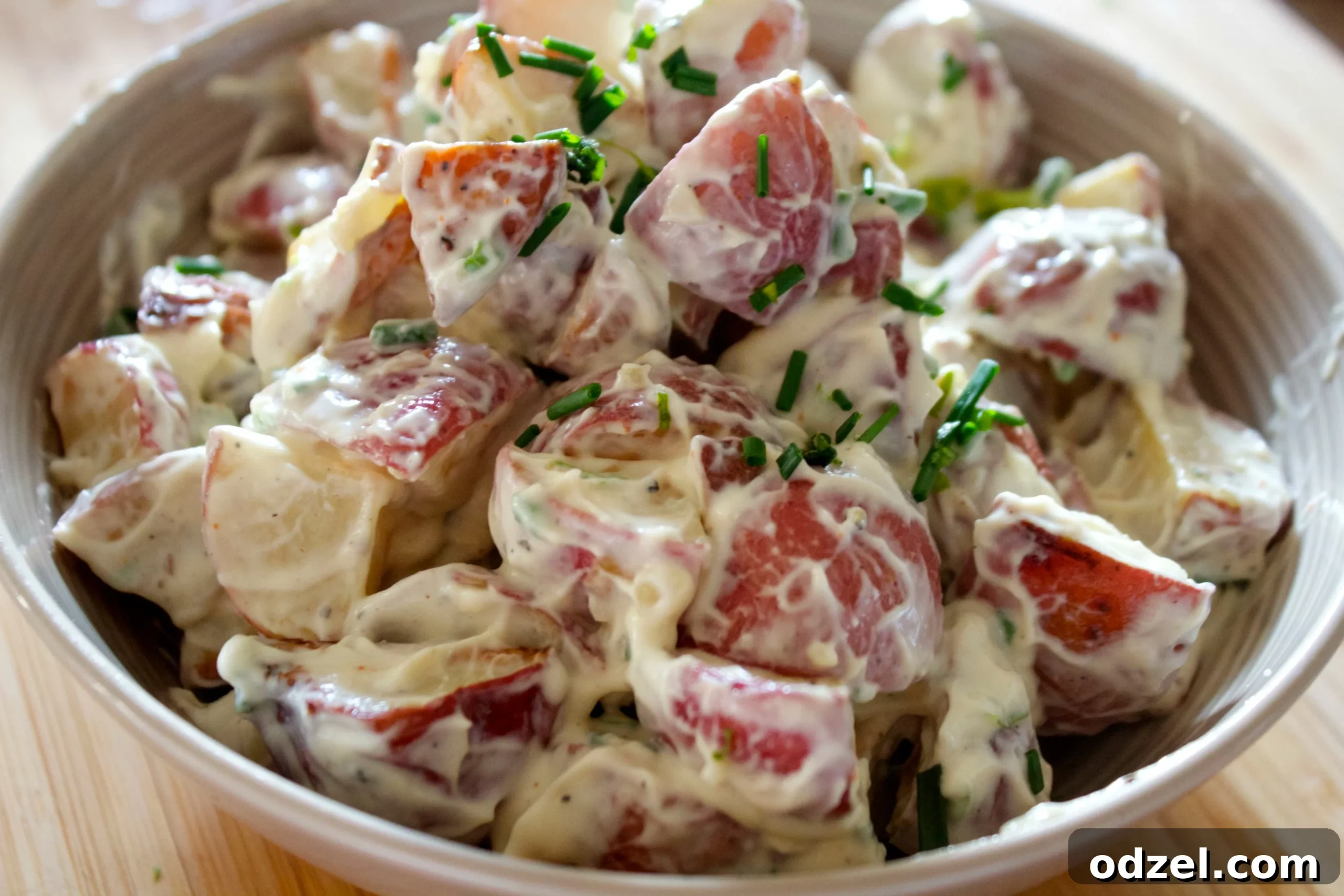 Golden Roasted Potato Salad 2 Creamy roasted potato salad with tender potatoes and tangy garlic mayo, garnished with fresh chives, perfect for summer