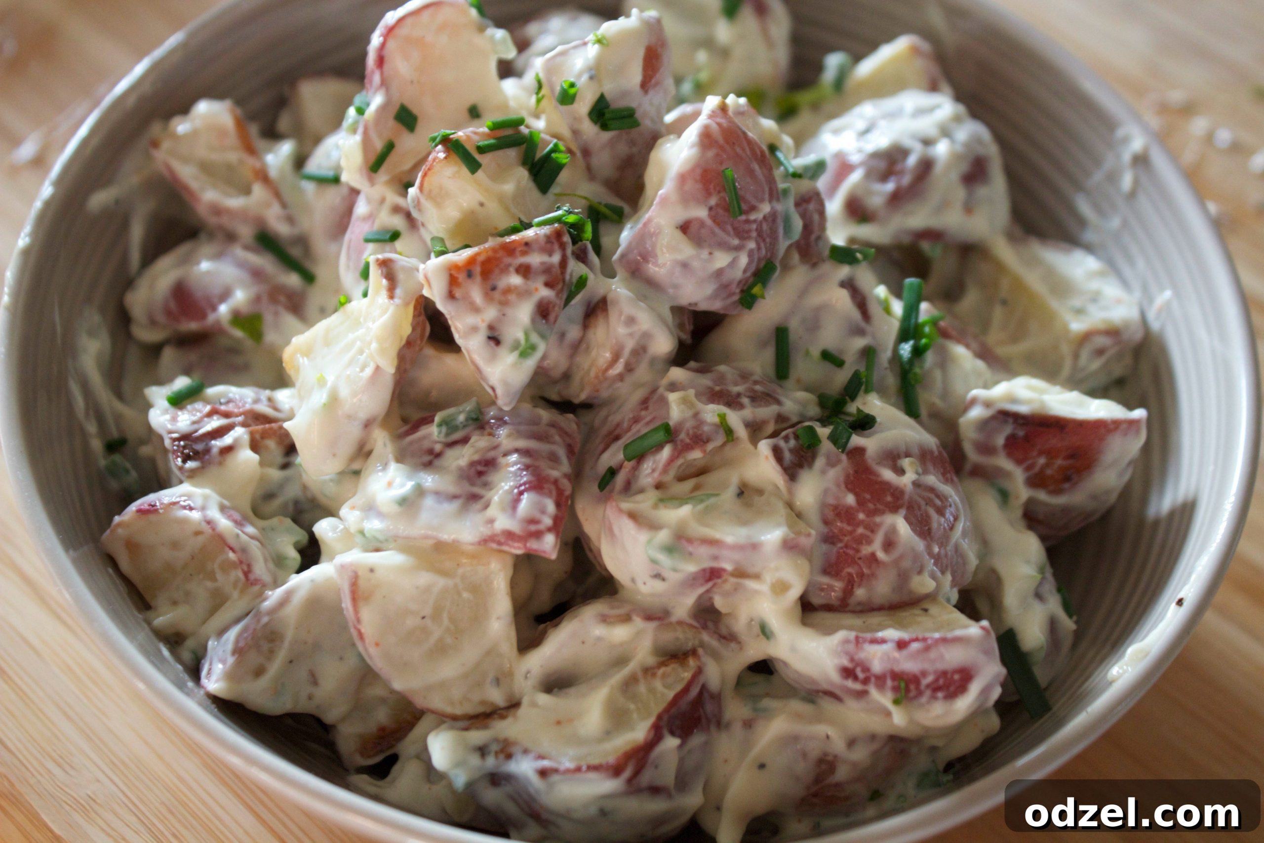 Golden Roasted Potato Salad 3 Close-up of roasted garlic potato salad with finely chopped chives, ready to serve
