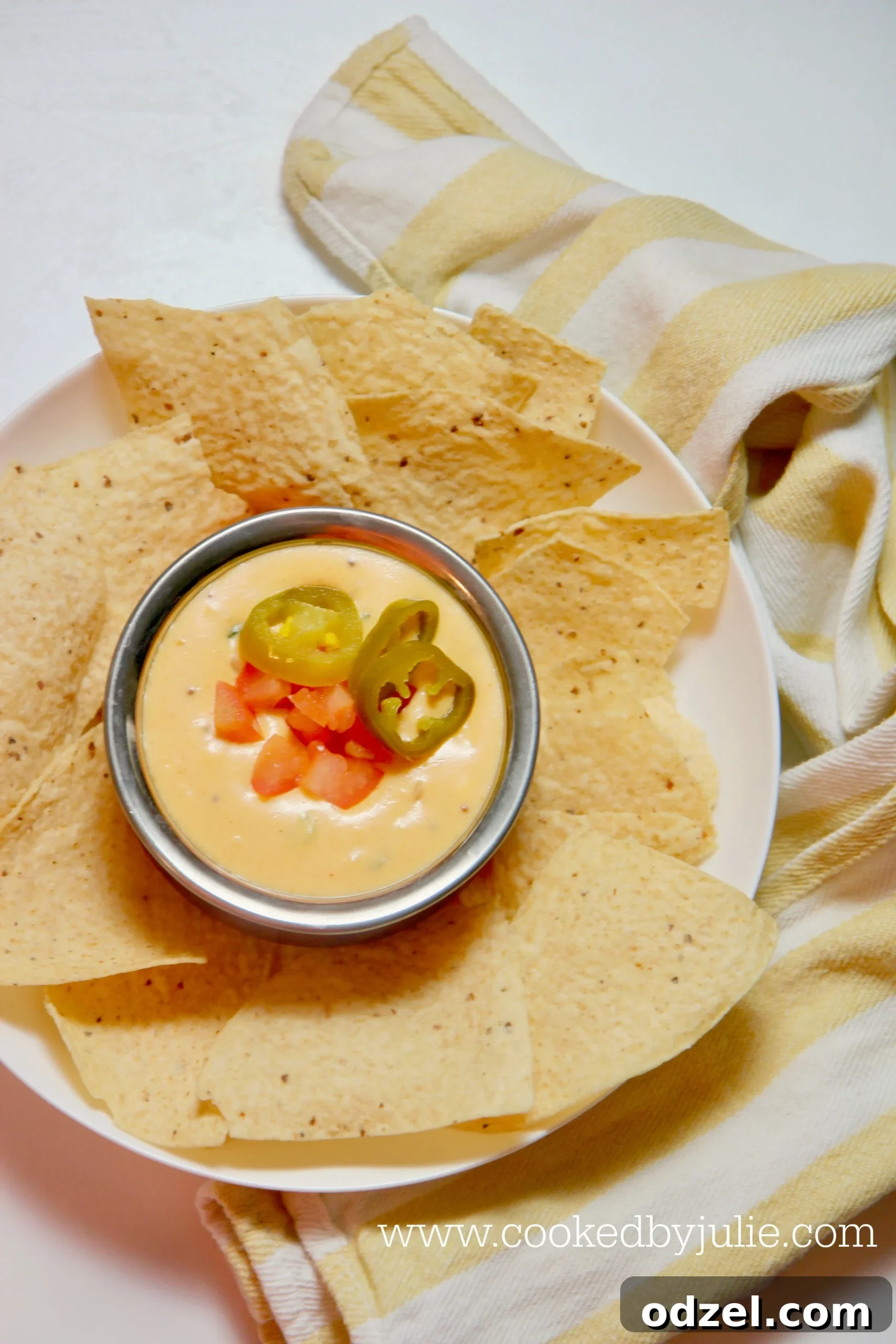 Creamy and cheesy queso dip made with real cheese, garnished with fresh cilantro.