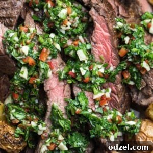 churrasco with chimichurri and roasted potatoes served on a plate.
