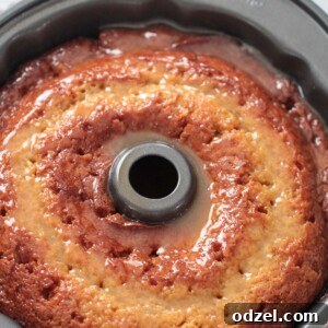 Crack Cake in a bundt pan, a delicious yellow cake with a butter glaze.