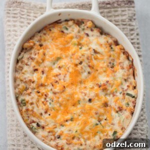 hot cheesy corn dip in a white dish.