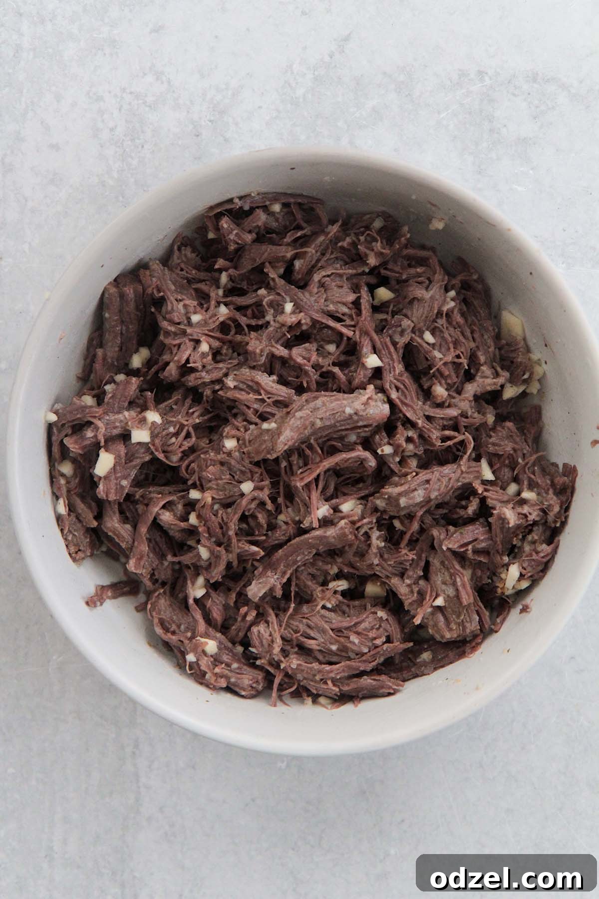 Golden Crispy Shredded Beef 5 Finely shredded beef mixed with minced garlic, ready for the final frying stage.