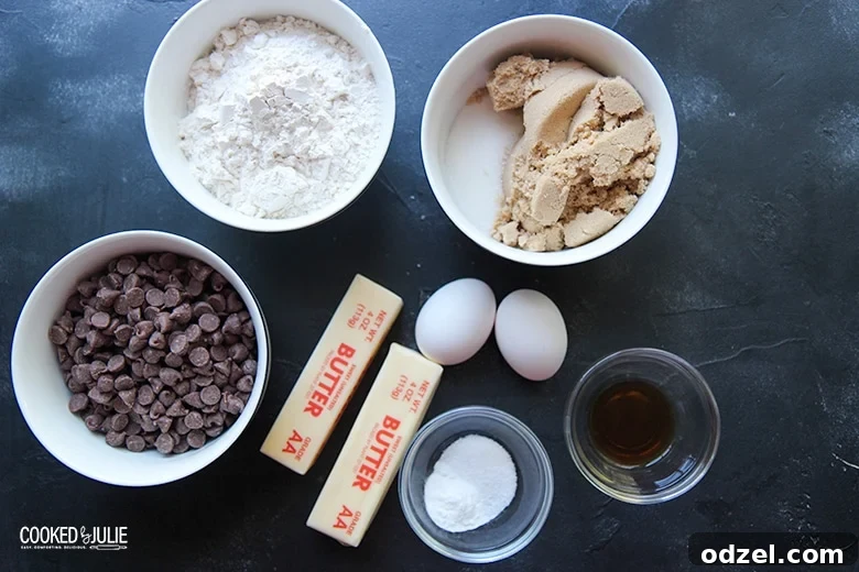 Ultimate Chocolate Chip Indulgence 3 A vibrant display of essential chocolate chip cookie ingredients arranged in small bowls, alongside softened butter and fresh eggs, ready for baking.