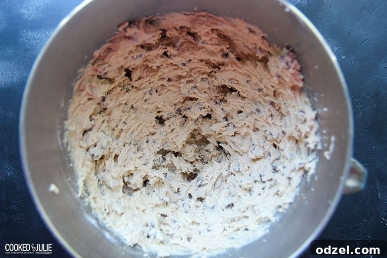 Ultimate Chocolate Chip Indulgence 5 A close-up shot of perfectly mixed chocolate chip cookie dough in a spacious bowl, ready for scooping and baking, showcasing the integrated chocolate chips.