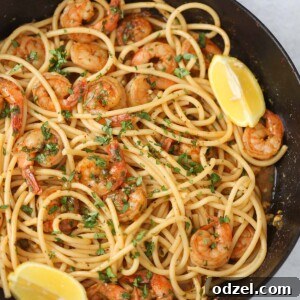 Cajun shrimp scampi with pasta in a skillet.