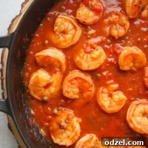 Cuban shrimp creole (enchilado de camarones) with red sauce in a black skillet up close.