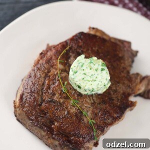 Flawless Pan Seared Ribeye 2 Pan-seared ribeye steak, golden brown and juicy, topped with melting herb butter.