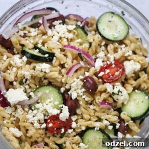 Greek pasta salad in a large glass bowl.