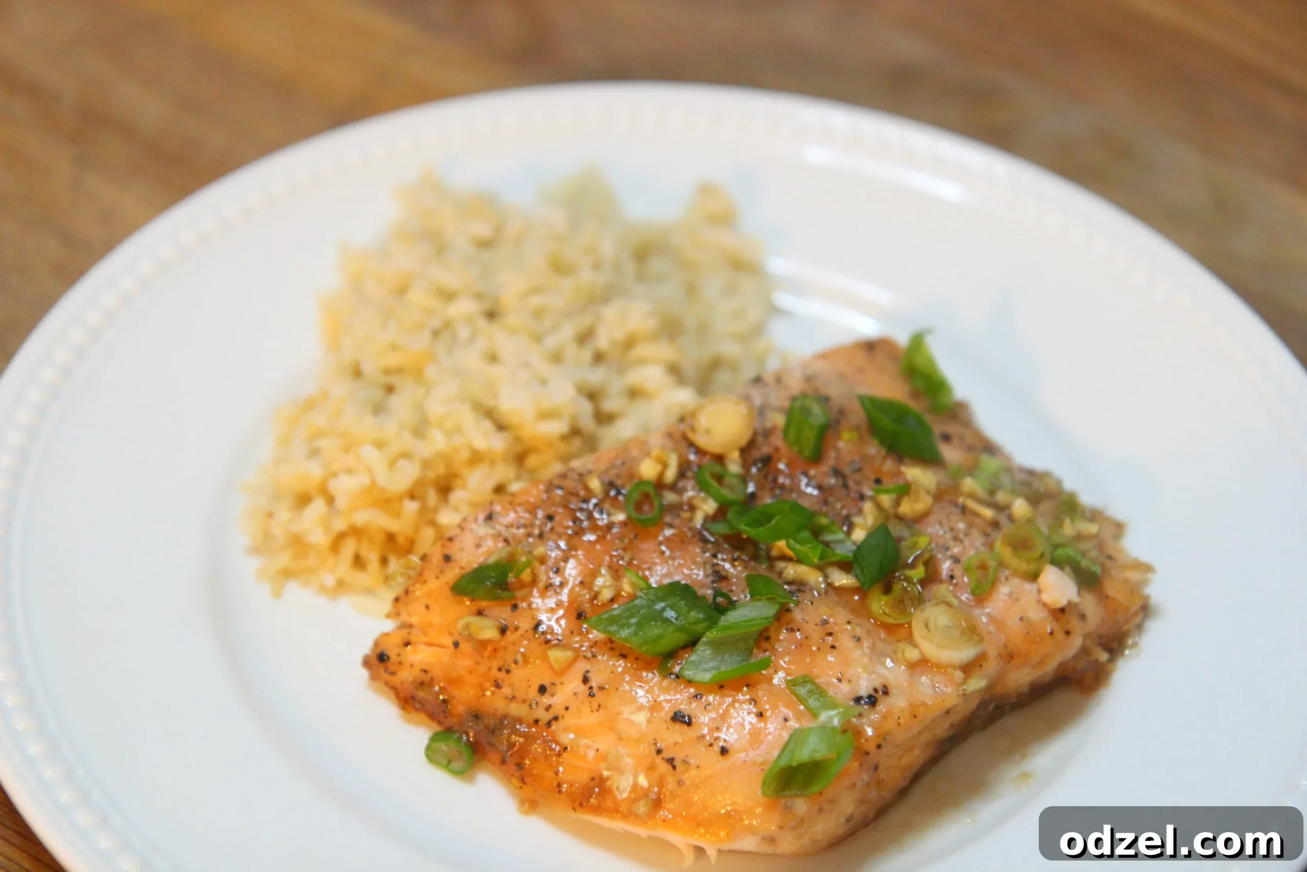 Golden Honey Salmon 2 Delicious honey glazed salmon fillet with garlic and scallions, perfectly cooked and ready to serve.