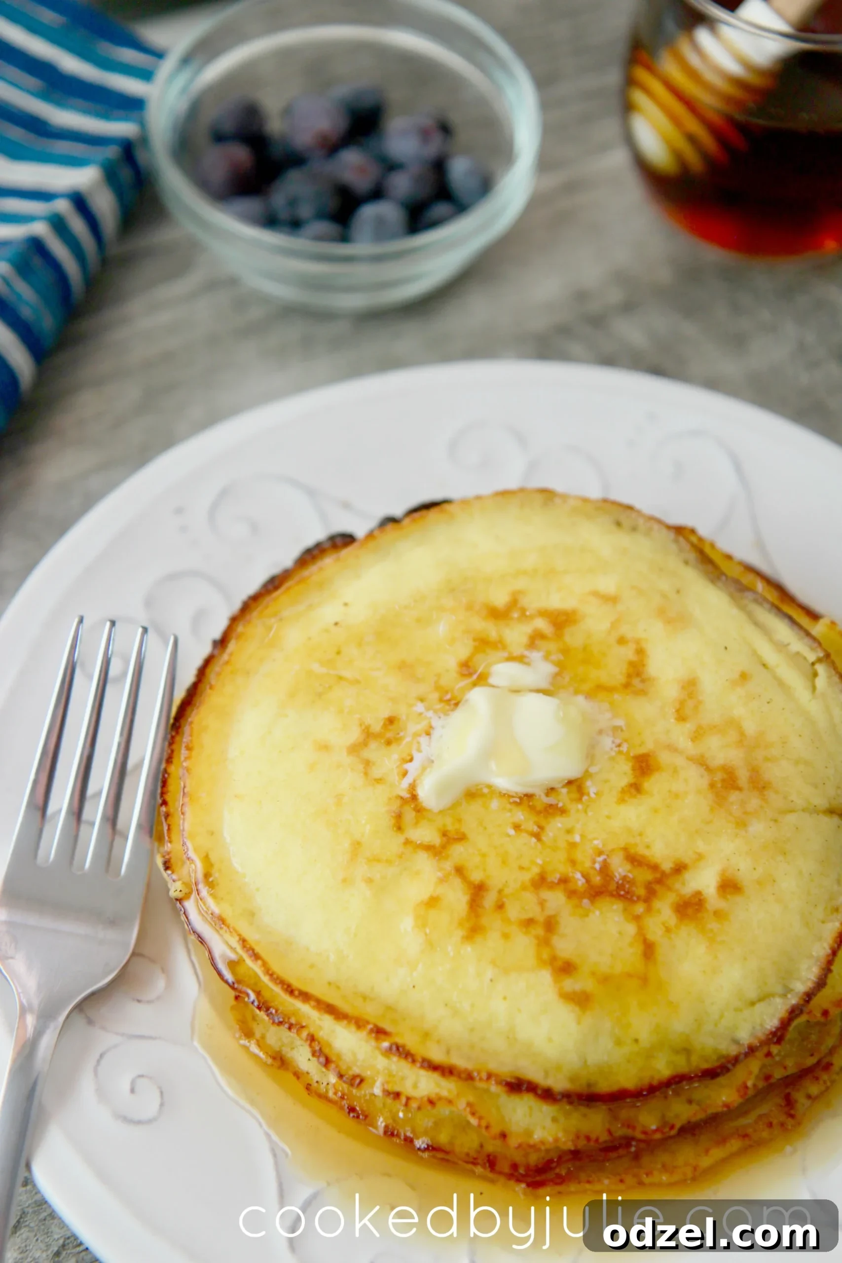 Keto-friendly low-carb pancakes with butter and sugar-free syrup. Add blueberries for an extra garnish. 