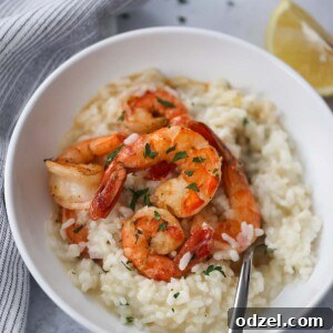 shrimp risotto in a white bowl with a fork.