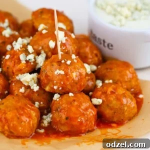 Honey buffalo chicken meatballs, garnished with blue cheese crumbles.