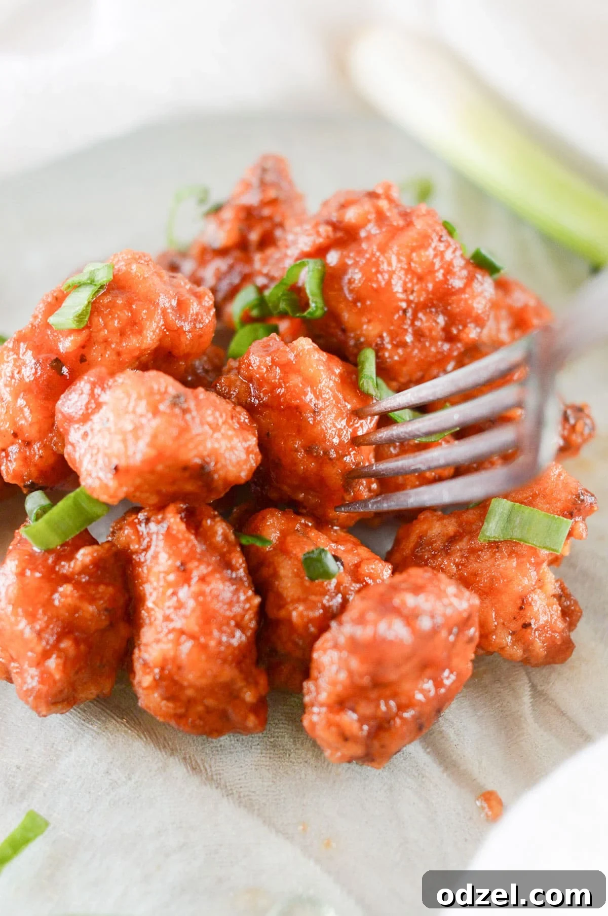 Sweet and Smoky Boneless Chicken Bites 6 boneless wings coated in barbecue sauce with a fork