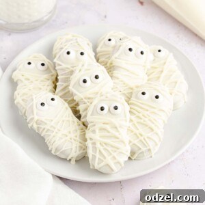nutter butter mummies on a white plate.