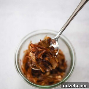 caramelized onions in a bowl with a spoon.