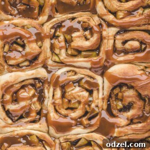 Twelve caramel apple cinnamon rolls up close.
